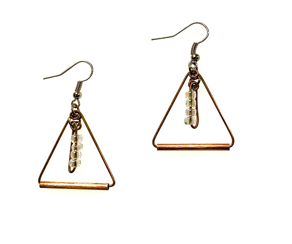 A pair of triangle-shaped brass earrings with clear seed beads dangling in center. Earrings have earwires.